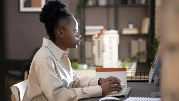 Business colleagues working in an office — an article about cost to build a delivery app in Nigeria