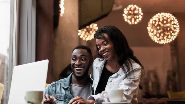 A couple working on a laptop in an office — an article about cost to build a SaaS app in Nigeria