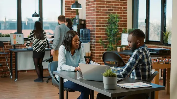 African business colleagues in a meeting in an office — how Nigerian hotels can get more direct bookings