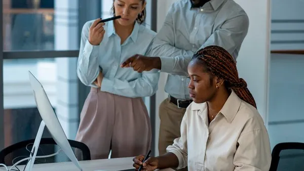 Business colleagues working in an office — how to add a chatbot to your website