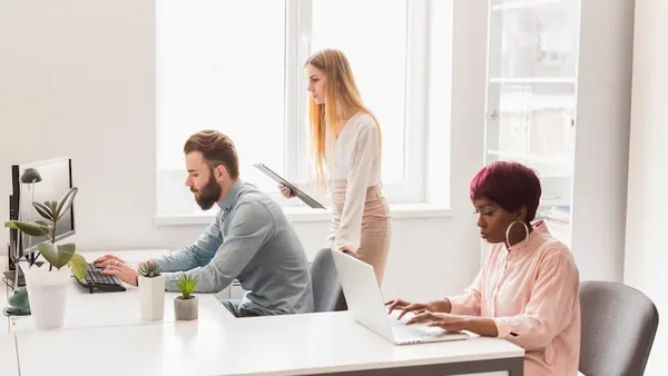 Business colleagues working in an office — an article about add AI to your business website