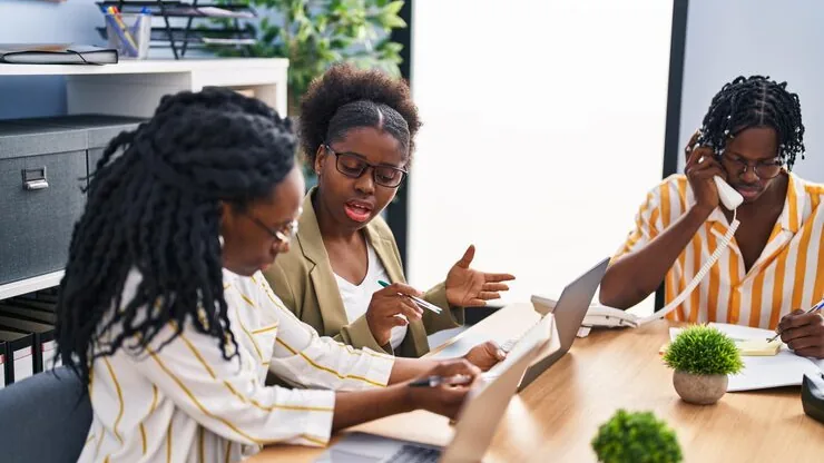African business colleagues working in an office — how to add ChatGPT to a business website