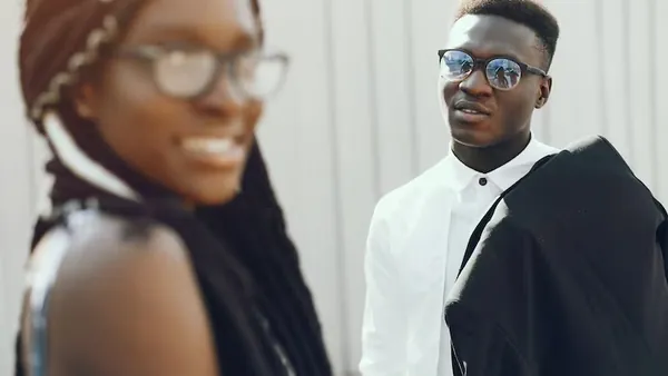 African couple working in an office — how to add ChatGPT to a mobile app
