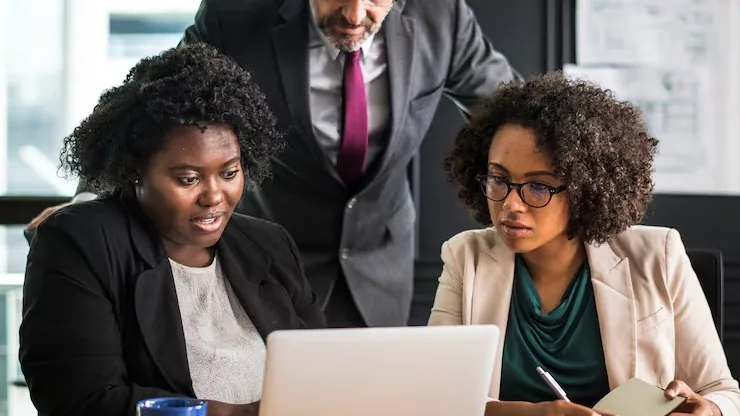 Business colleagues in a meeting in an office — an article about automate business documents with AI