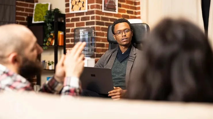 African couple working on a laptop in an office — an article about automate customer onboarding with AI
