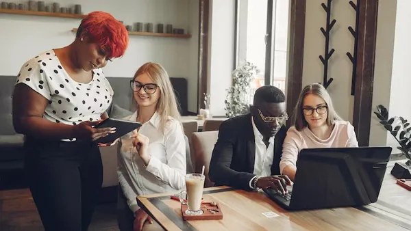 An African businessman working on a laptop in an office — how to automate lead qualification with AI