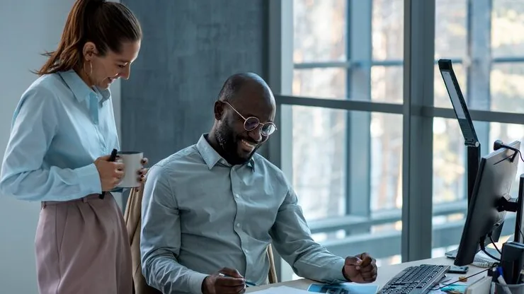 Business colleagues working in an office — how to automate your CRM