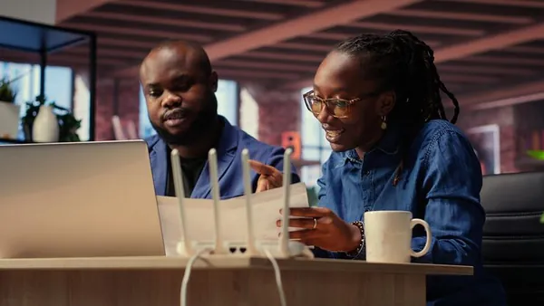 An African businesswoman working in an office — an article about software development scams in Nigeria