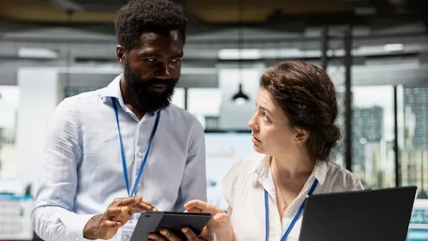 African business colleagues working in an office — an article about website development scams in Nigeria