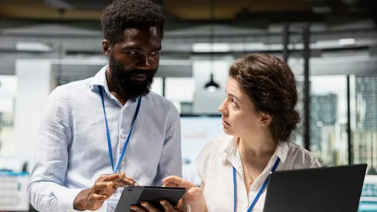 African business colleagues working in an office — an article about website development scams in Nigeria