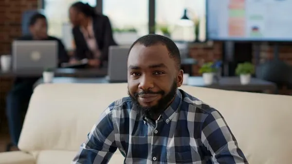 African business colleagues on a laptop at home — how to budget for app development in Nigeria