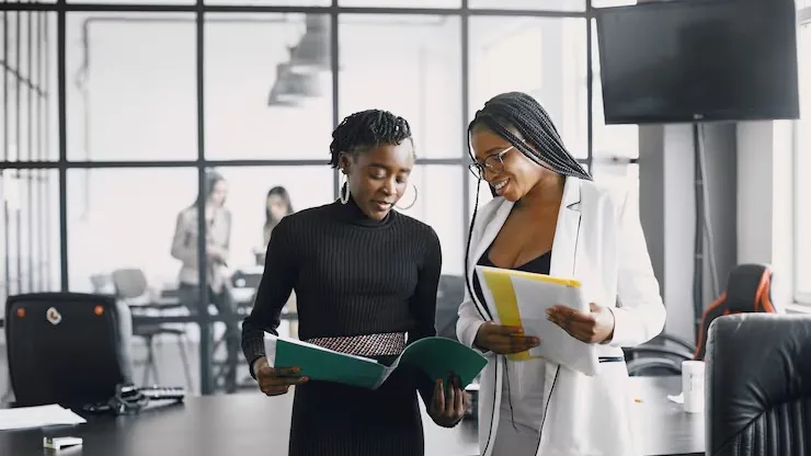 Business colleagues on a call in a cafe — an article about build a beauty booking app in Nigeria