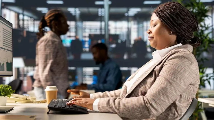 An African businesswoman working in an office — an article about build a business directory app in Nigeria