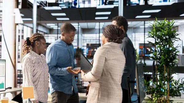 Business colleagues reviewing over documents in an office — an article about data-driven business in Nigeria