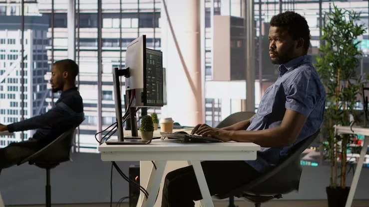 Business colleagues working in an office — how to build a delivery app in Nigeria