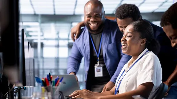 Business colleagues at work over documents in an office — an article about digital customer experience