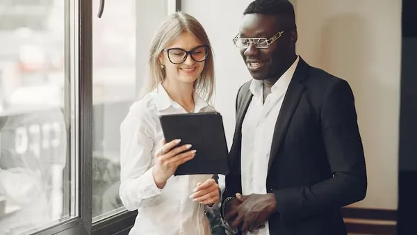 An African businessman working in an office — an article about mobile app with document uploads