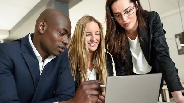 African business colleagues in a meeting on a laptop in an office — how to build a multi-vendor e-commerce website