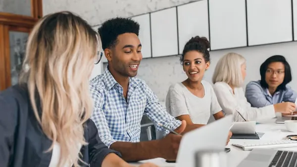 An African businesswoman in a meeting on a laptop in an office — an article about build a travel app in Nigeria