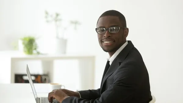 An African businessman at work in an office — how to build an integrated business system