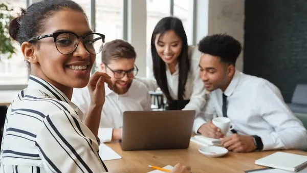 Business colleagues at work in an office — how to build an online booking business