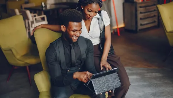 A couple working with a tablet in a cafe — how to calculate app ROI