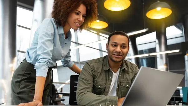 Business colleagues working in an office — how to calculate digital marketing ROI