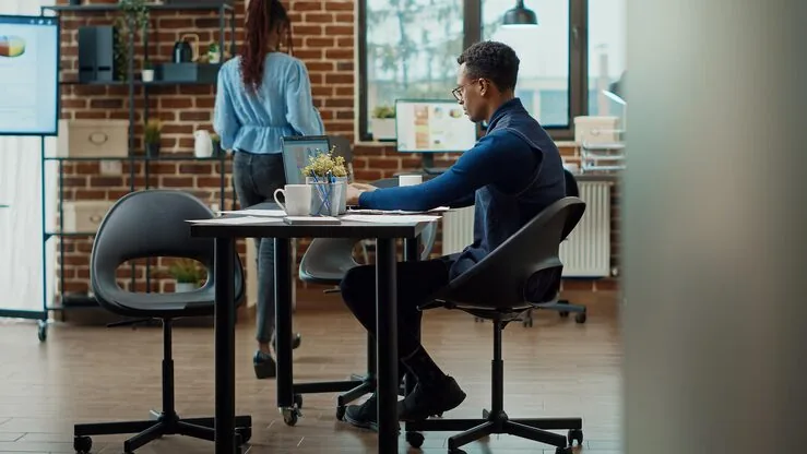 An African businessman reviewing over documents in an office — how to calculate website ROI
