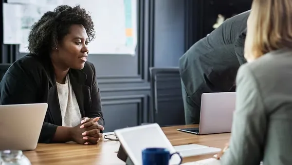 Business colleagues in a meeting in an office — how to choose a software development company in Nigeria