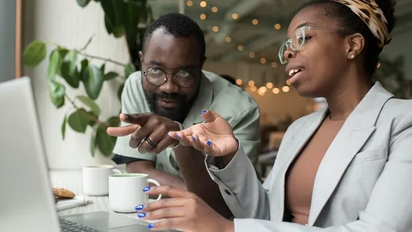 Business colleagues in a meeting in an office — how to choose a technology partner in Nigeria