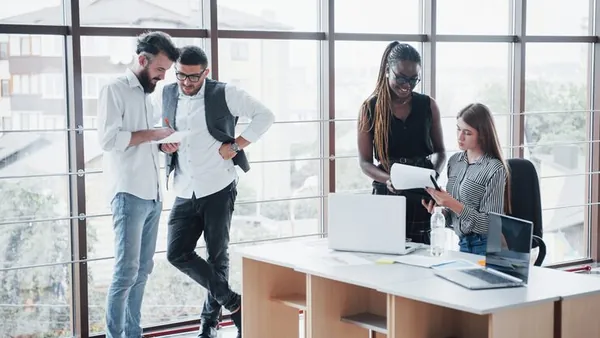 Business colleagues in a meeting in an office — how to choose a website designer in Nigeria