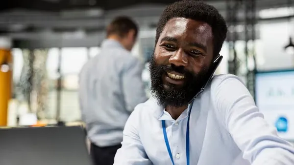 An African businessman on a call on a laptop in an office — how to get more leads from your website