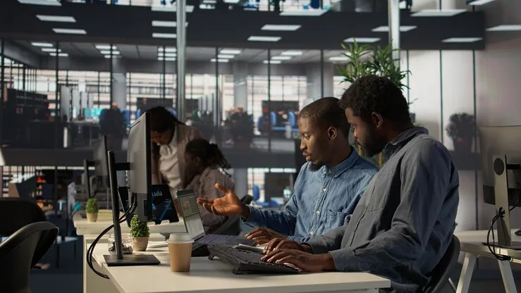African business colleagues planning in an office — how to grow a small business in Nigeria