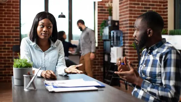 A manager on a call in an office — how to improve customer retention in Nigeria