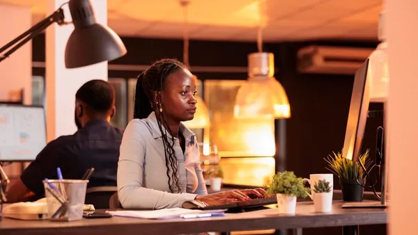 An African businesswoman working at a computer in an office — how to increase e-commerce conversion rates in Nigeria