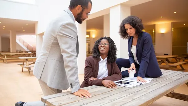 Business colleagues working in an office — how to manage an AI implementation project