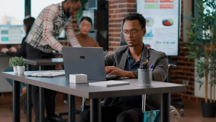 A businessman planning on a laptop in an office — how to measure AI success