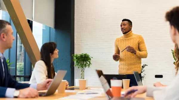 African business colleagues in a meeting in an office — how to protect your business when hiring developers