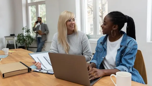 Business colleagues working in an office — how to sell through WhatsApp in Nigeria