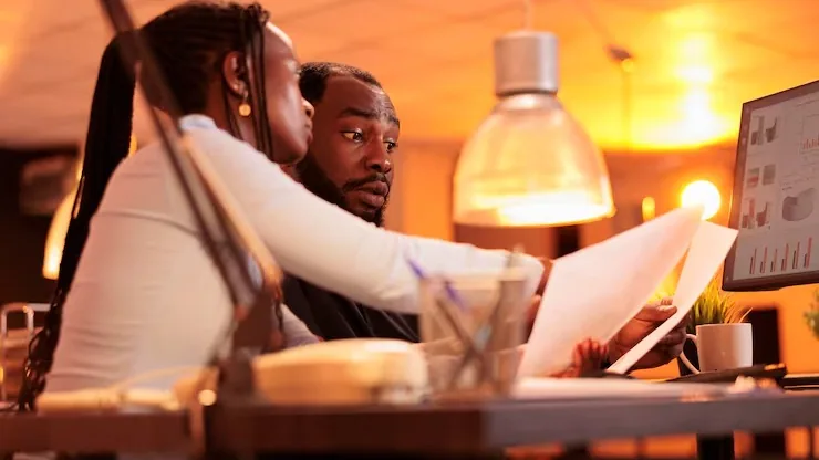 Business colleagues reviewing at a computer in an office — how to structure a website for SEO