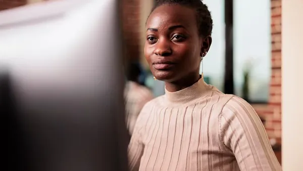African business colleagues working over documents in an office — how to use AI to improve business decisions