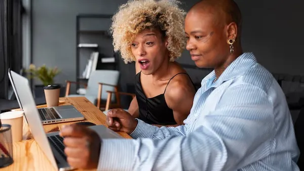 Business colleagues working in an office — how to use technology to reduce operating costs