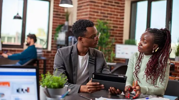African business colleagues reviewing in an office — how to validate an app idea in Nigeria