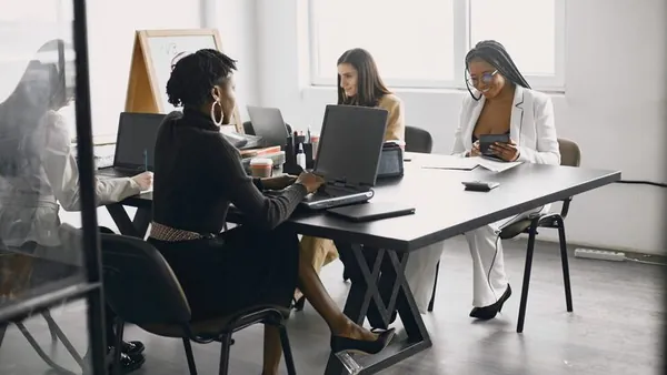 Business colleagues in a meeting in an office — an article about legal document automation in Nigeria