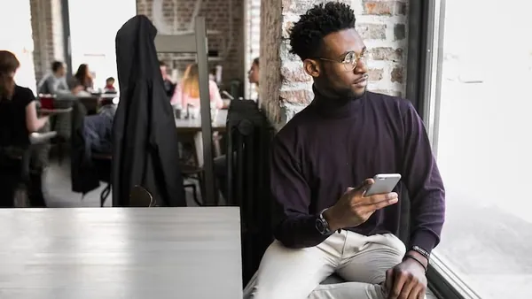 An African businessman working with a tablet in an office — an article about mobile app development companies in Nigeria