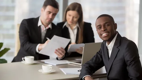 African business colleagues reviewing in an office — an article about mobile app feature checklist