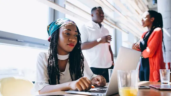 African business colleagues working in an office — an article about NGO management software in Nigeria