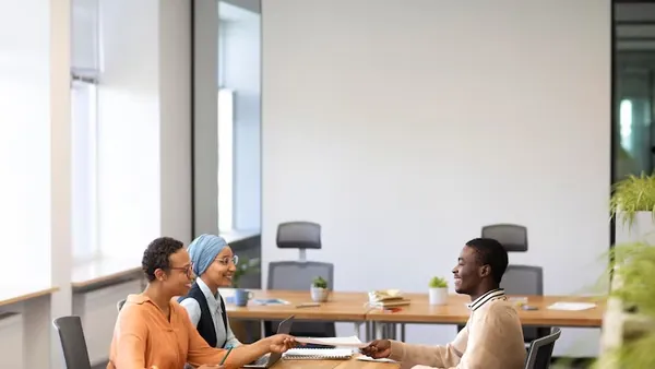 A businessman in a meeting in an office — an article about outsourcing website development in Nigeria