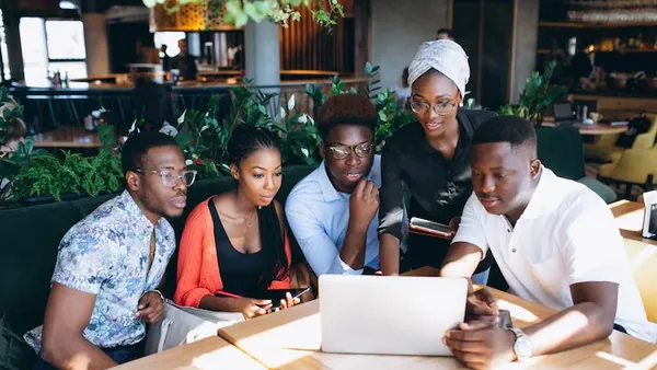 African business colleagues working in an office — an article about pharmacy management software in Nigeria