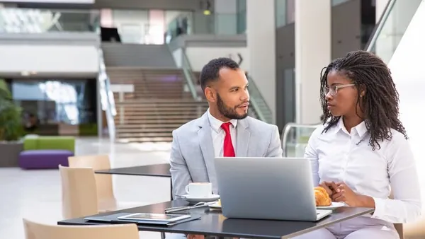 Business colleagues in a meeting in an office — an article about project management software for Nigerian construction